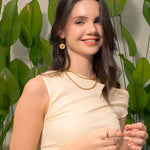 Starburst Charm Gold Huggie Earrings by Lavana, on model; modern Textured disc with raised star motif