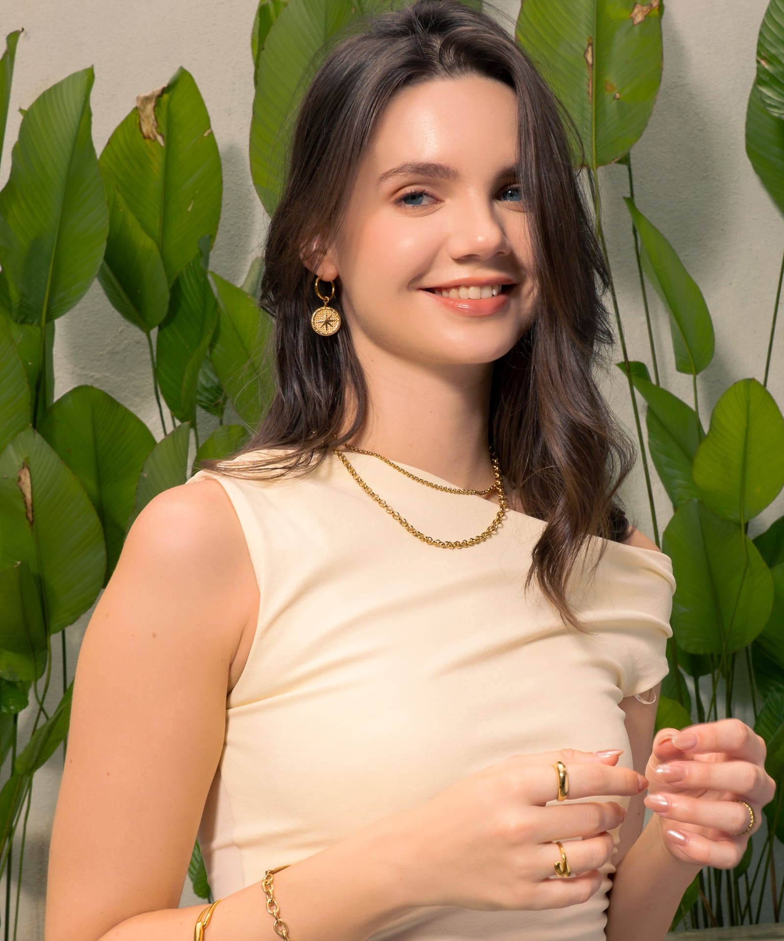 Starburst Charm Gold Huggie Earrings by Lavana, on model; modern Textured disc with raised star motif