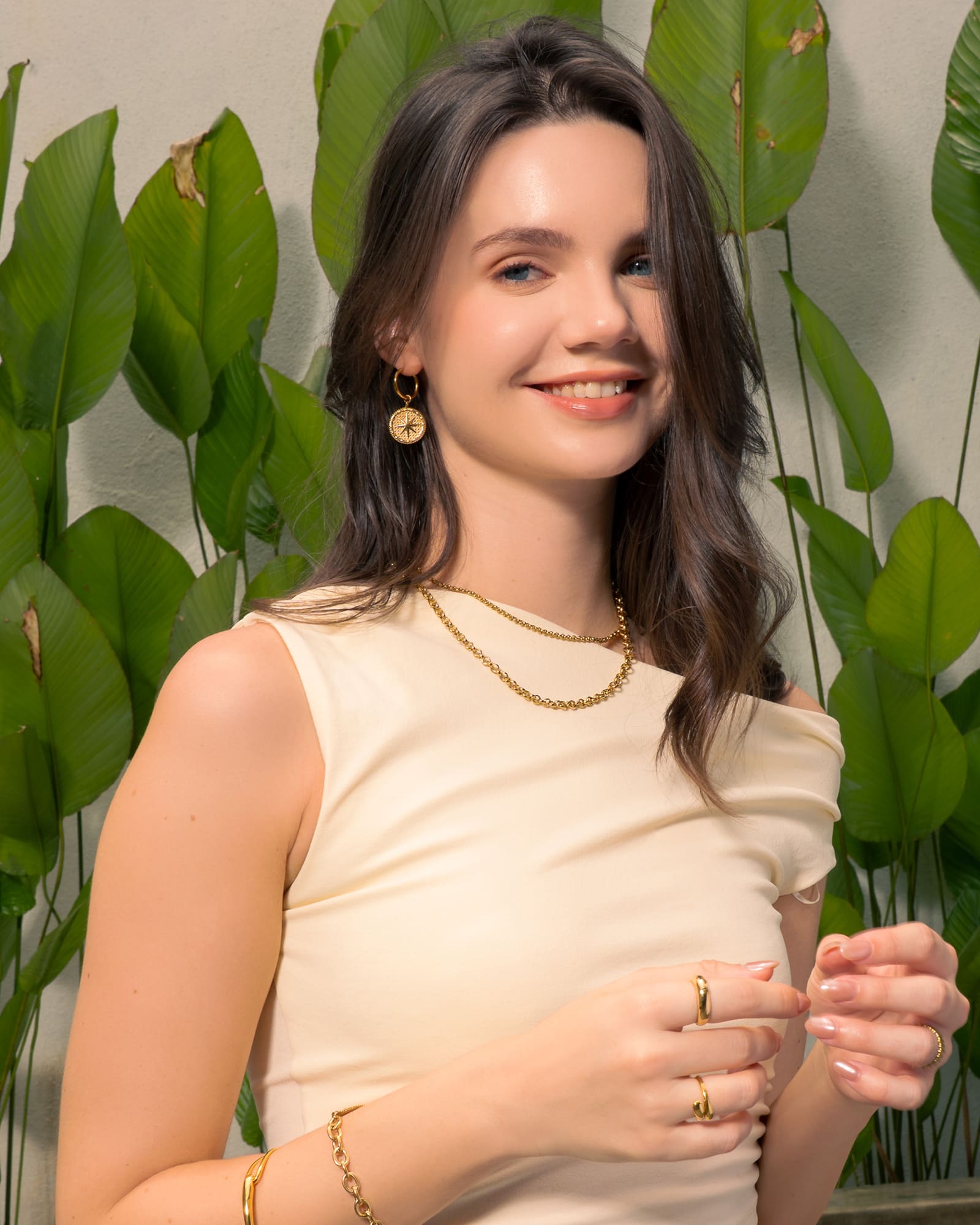 Starburst Charm Gold Huggie Earrings by Lavana, on model; modern Textured disc with raised star motif