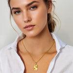 Sunburst Gold Tag Necklace by Lavana, on model; sunburst engraved rectangle tag on fine chain 