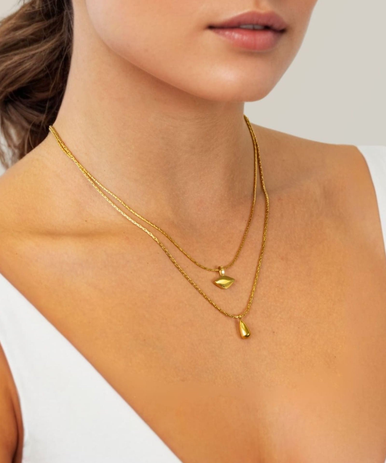 Sunshower Layered Gold Necklace by Lavana, on model; double layered chain with cloud charm and raindrop pendant