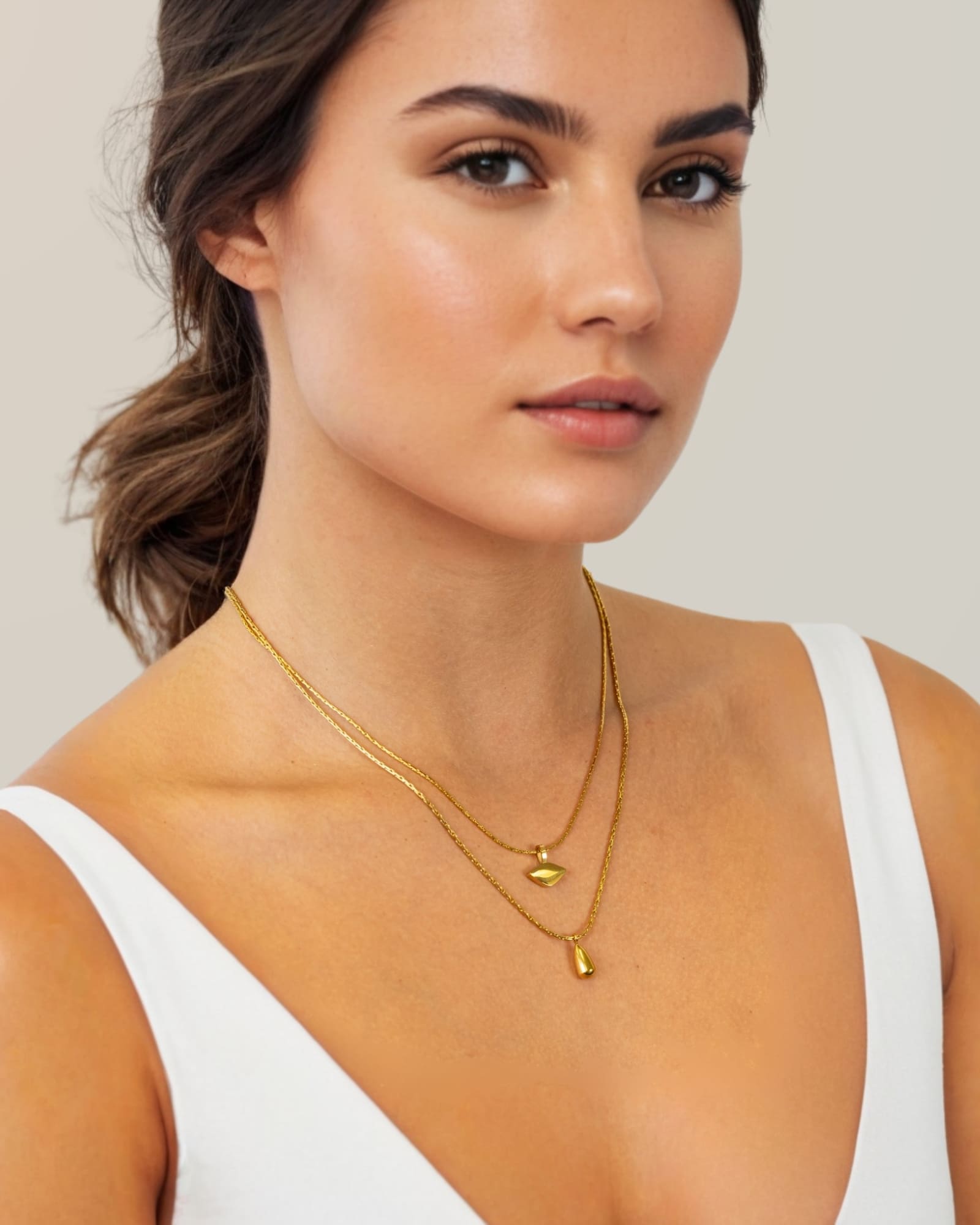 Sunshower Layered Gold Necklace by Lavana, on model; double layered chain with cloud charm and raindrop pendant