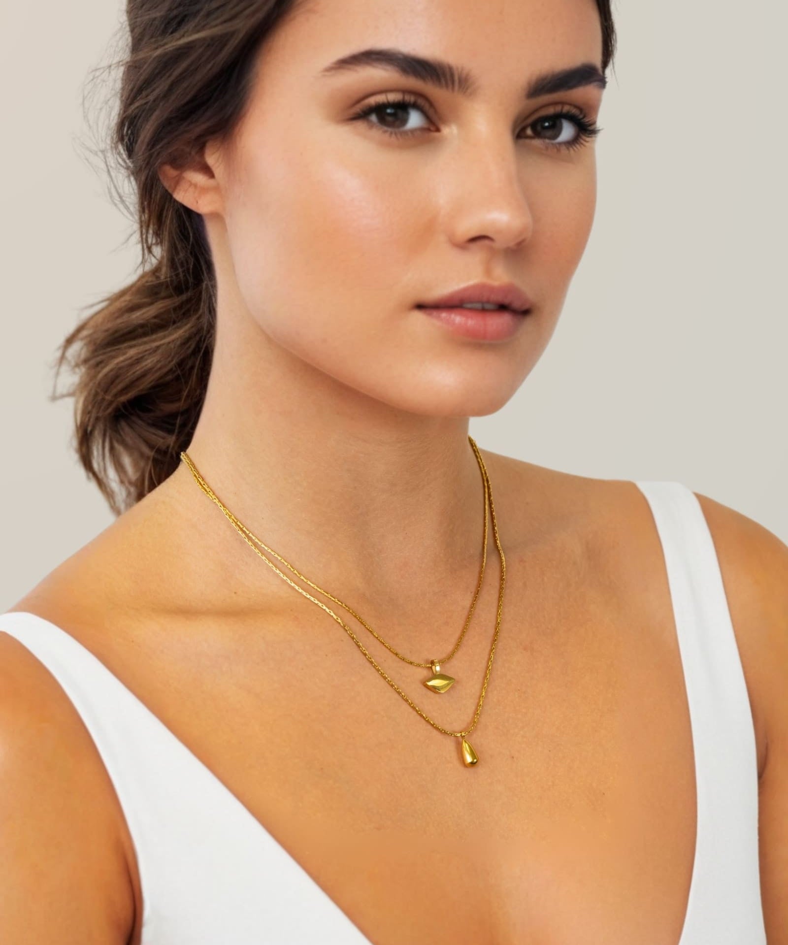 Sunshower Layered Gold Necklace by Lavana, on model; double layered chain with cloud charm and raindrop pendant