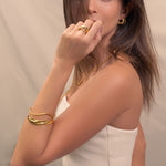 Sway Thin Gold Cuff Bracelet by Lavana, on model; modern slim V-shaped open cuff