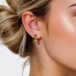 Sweetheart Gold Hoop Earrings by LAVANA on model four hearts stacked at the front