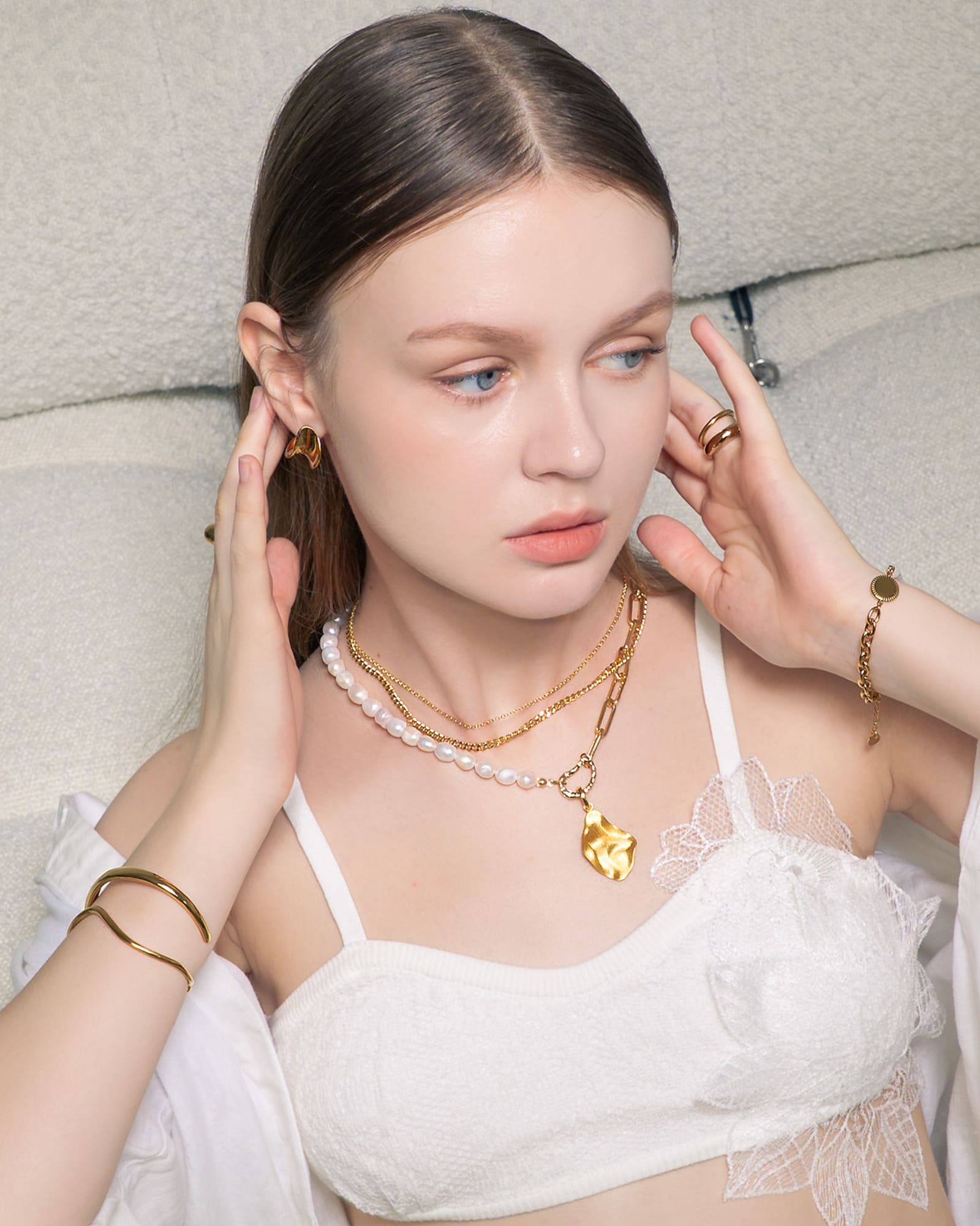 Swell Gold Stud Earrings by LAVANA,on model modern sculptural wave curve studs with high polish