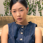 Swell Silver Stud Earrings by LAVANA, on model; polished wave curve studs