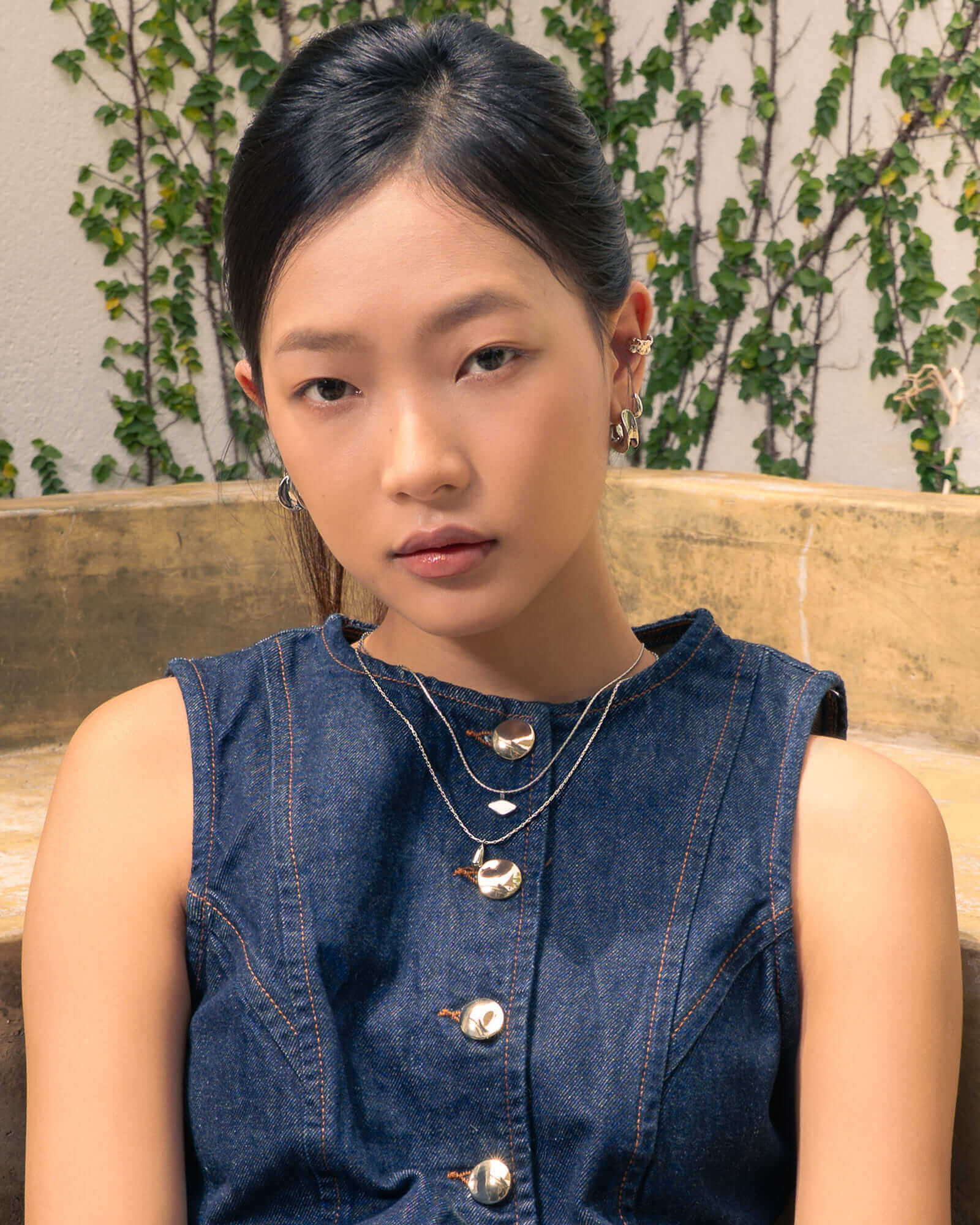 Swell Silver Stud Earrings by LAVANA, on model; polished wave curve studs