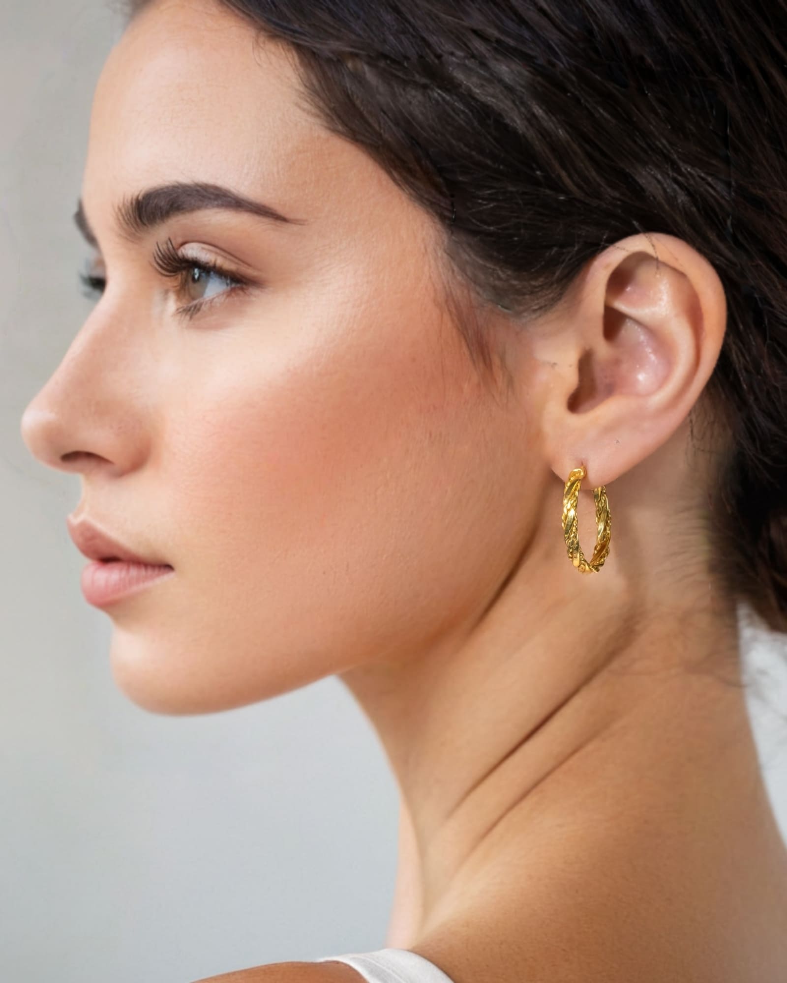 Tango Gold Hoop Earrings by Lavana on model full hoop with polished and textured halves on a flat profile