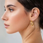 Tango Gold Hoop Earrings by Lavana on model full hoop with polished and textured halves on a flat profile