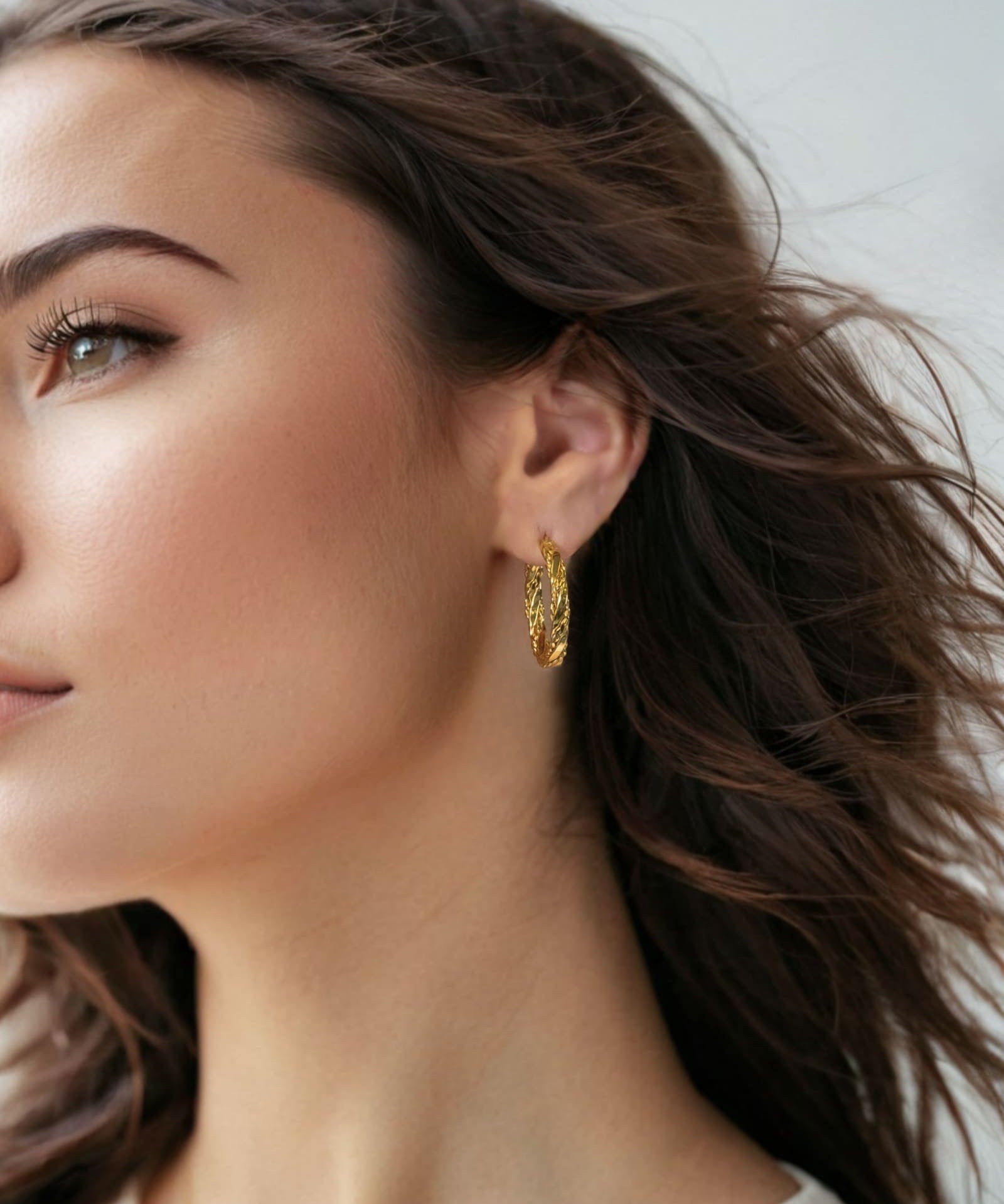 Tango Gold Hoop Earrings by Lavana on model full hoop with polished and textured halves on a flat profile