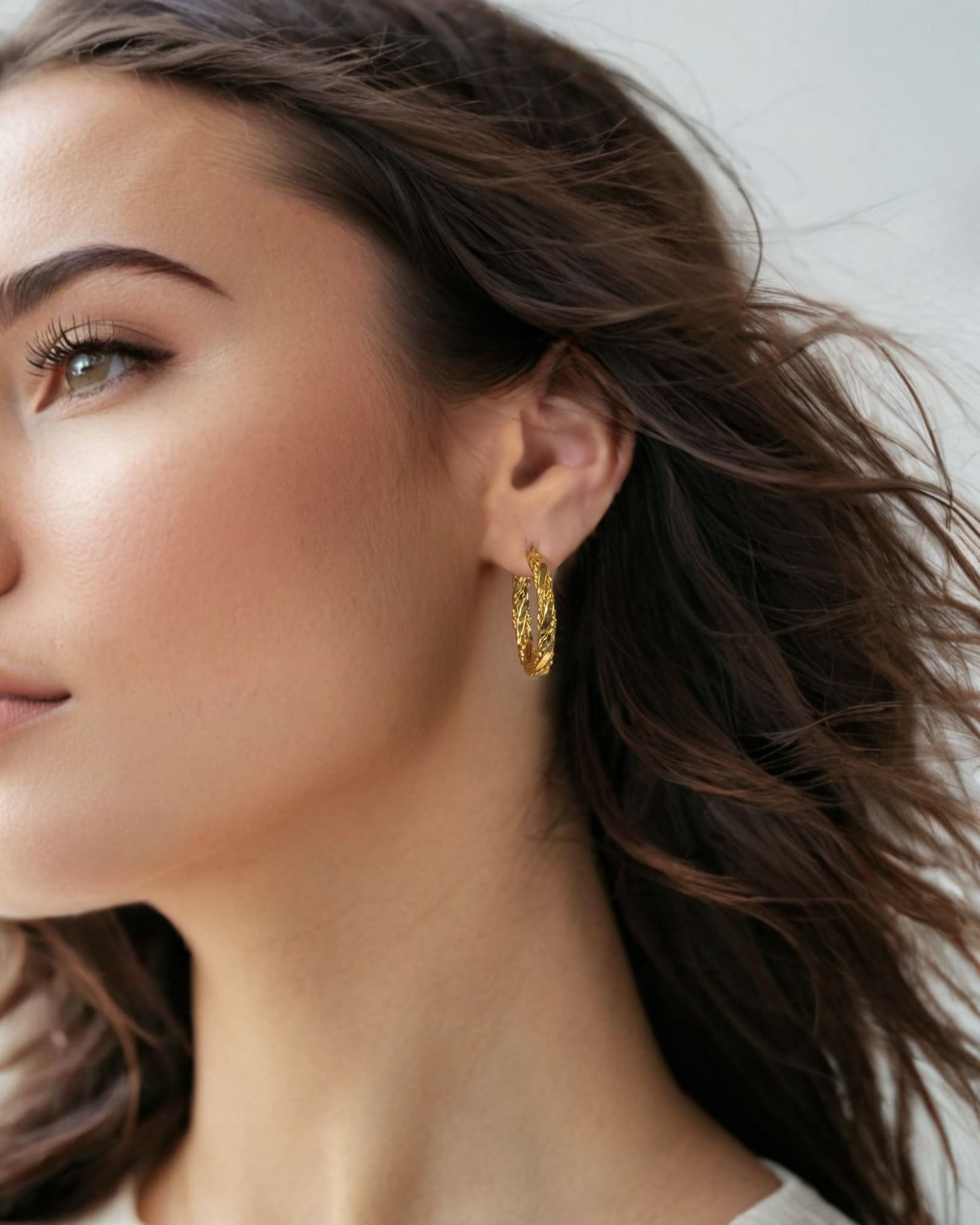 Tango Gold Hoop Earrings by Lavana on model full hoop with polished and textured halves on a flat profile