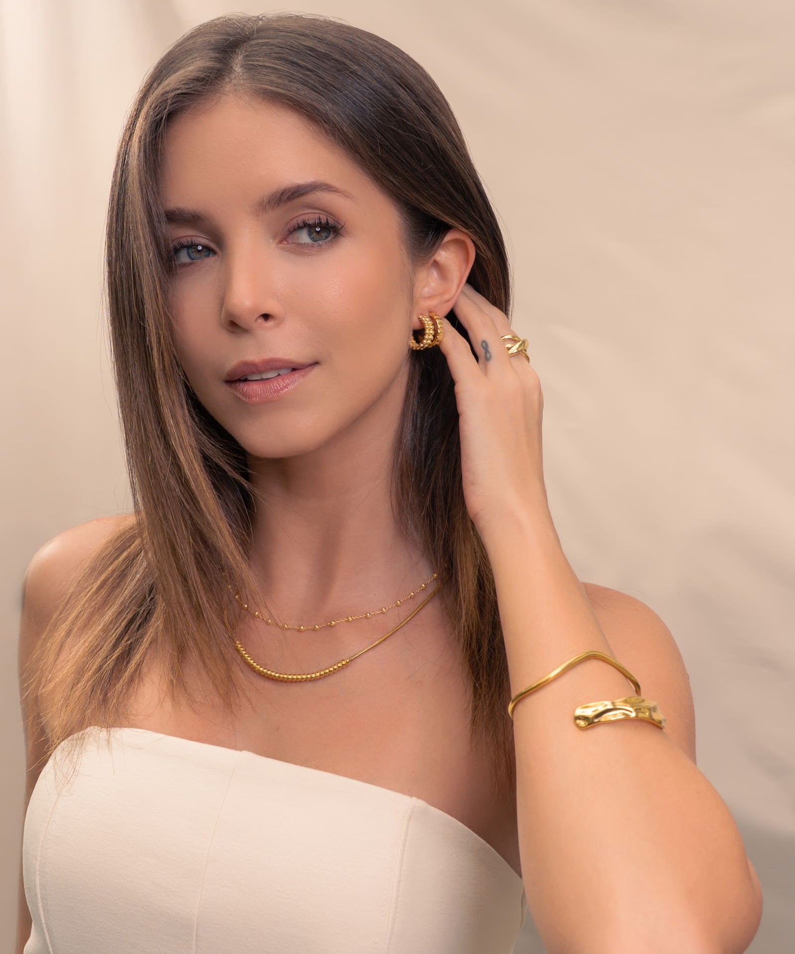 Tiny Pebbles Gold Hoop Earrings by Lavana, on model; double row of polished beads in an open dress hoops