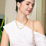 Twin Link Gold Drop Earrings by LAVANA, on model; interlocked polished classic links