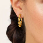 Twist Textured Gold Hoop Earrings by LAVANA on model large sculptural twisted hoops