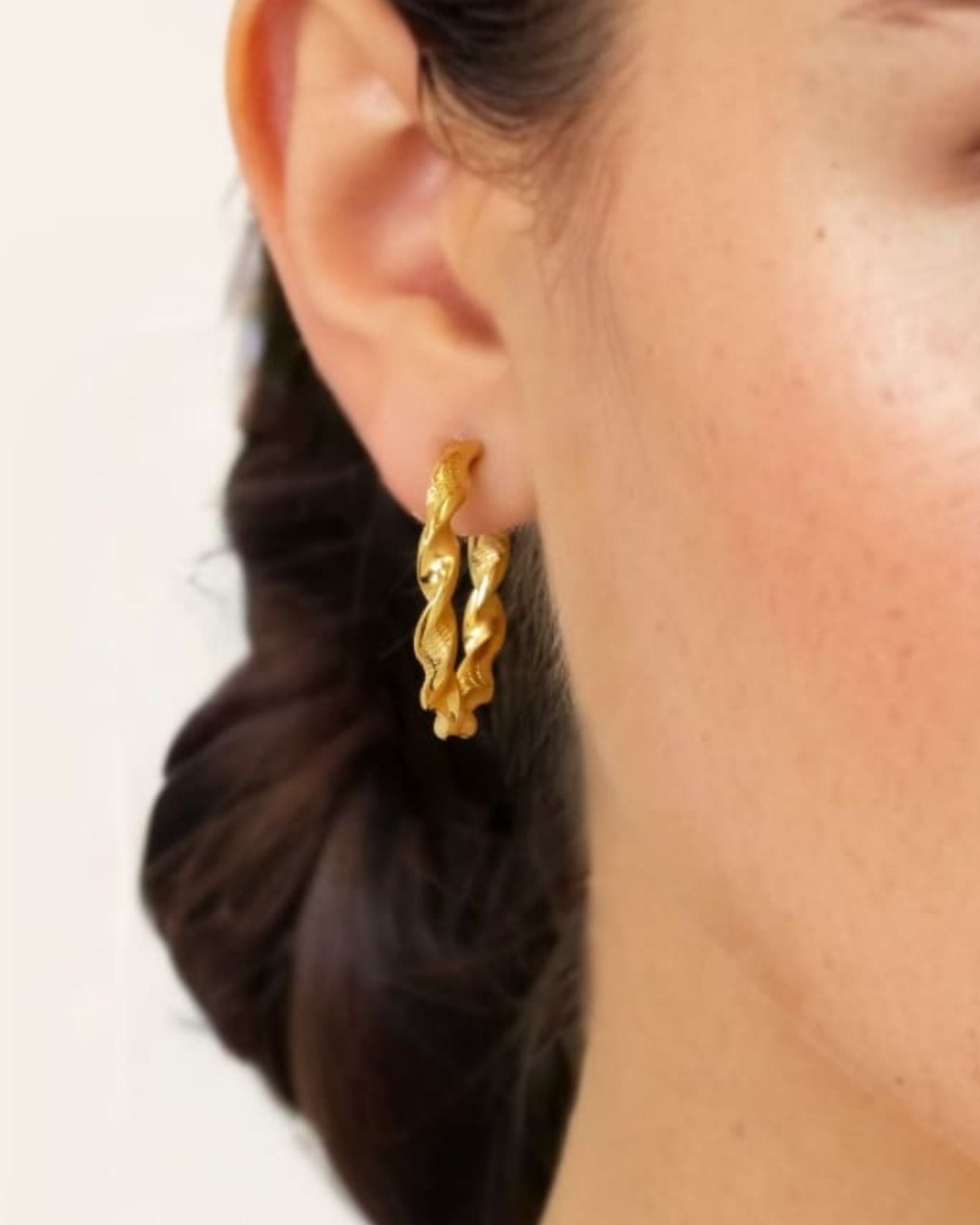 Twist Textured Gold Hoop Earrings by LAVANA on model large sculptural twisted hoops