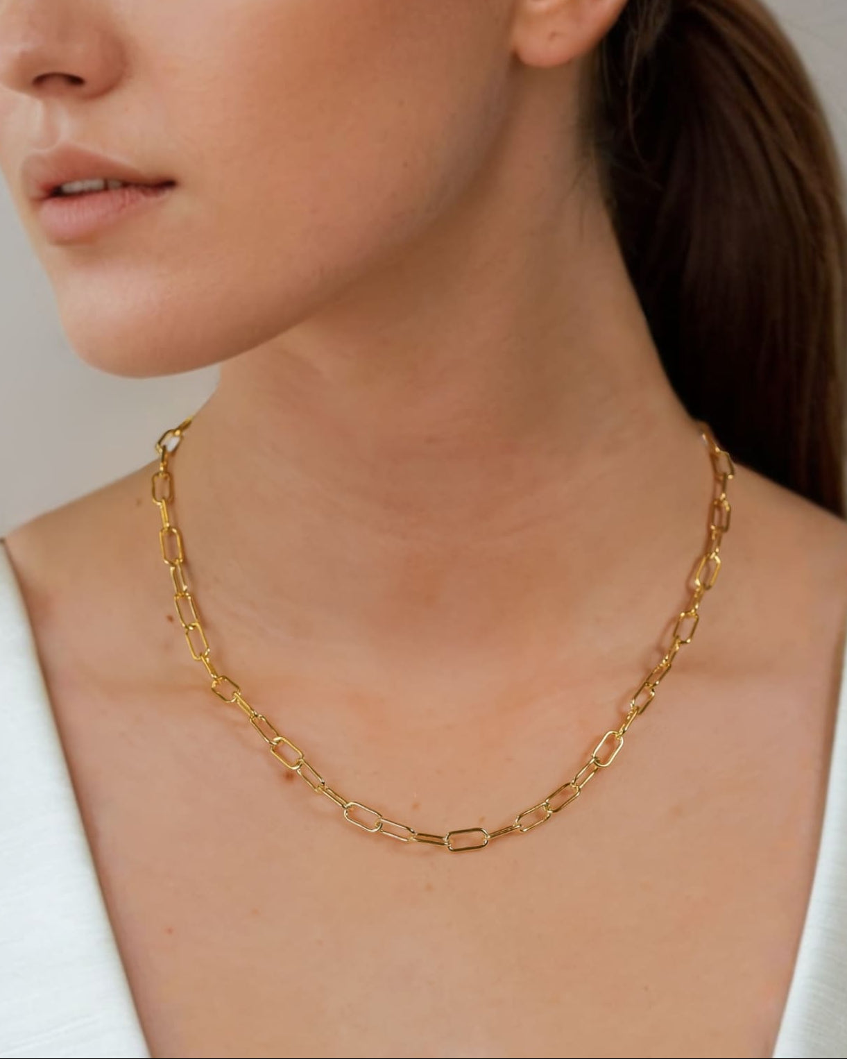 Verona Gold Paperclip Chain Necklace by Lavana on model with elongated polished links