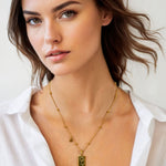 Virgo Gold Zodiac Tag Necklace by Lavana, on model; engraved tag front and back on beaded chain, back 