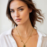 Virgo Gold Zodiac Tag Necklace by Lavana, on model; engraved tag front and back on beaded chain, back 