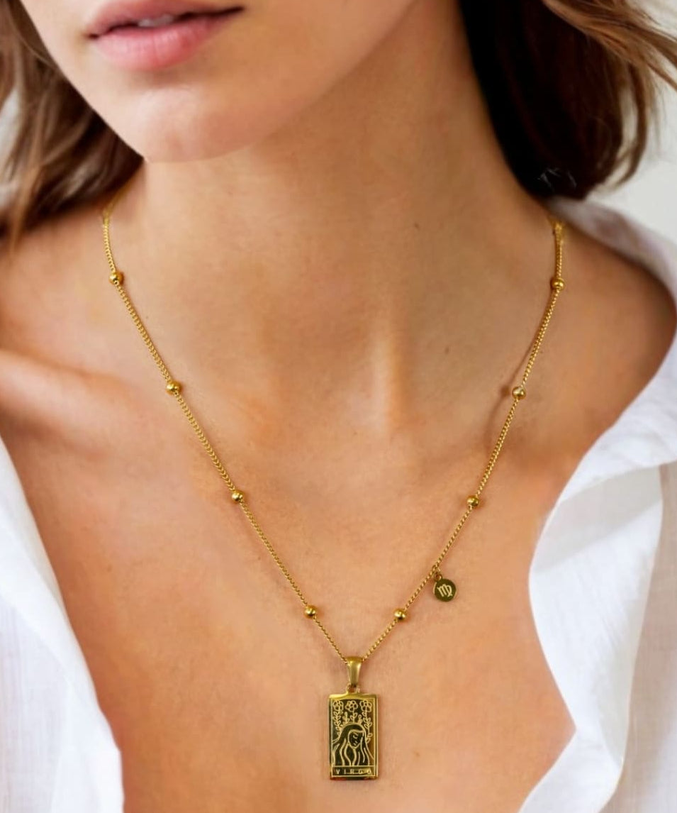 Virgo Gold Zodiac Tag Necklace by Lavana, on model; engraved tag front and back on beaded chain, front