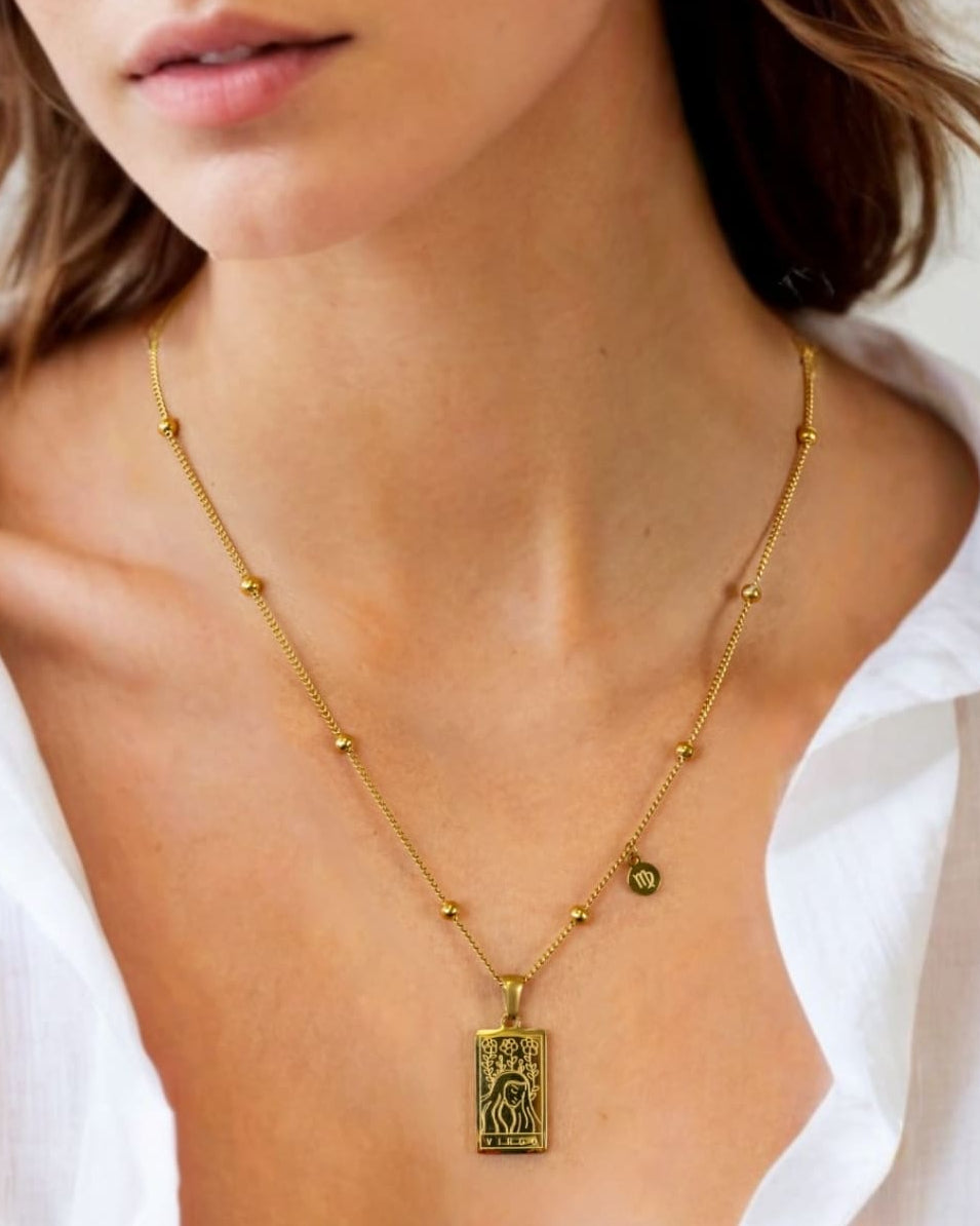 Virgo Gold Zodiac Tag Necklace by Lavana, on model; engraved tag front and back on beaded chain, front