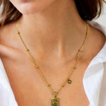 Virgo Gold Zodiac Tag Necklace by Lavana, on model; engraved tag front and back on beaded chain, front
