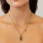 Virgo Gold Zodiac Tag Necklace by Lavana, on model; engraved tag with constellation on beaded chain, front