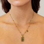 Virgo Gold Zodiac Tag Necklace by Lavana, on model; engraved tag with constellation on beaded chain, front